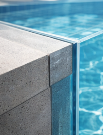 Close-up of concrete corner meeting acrylic pool panel edge