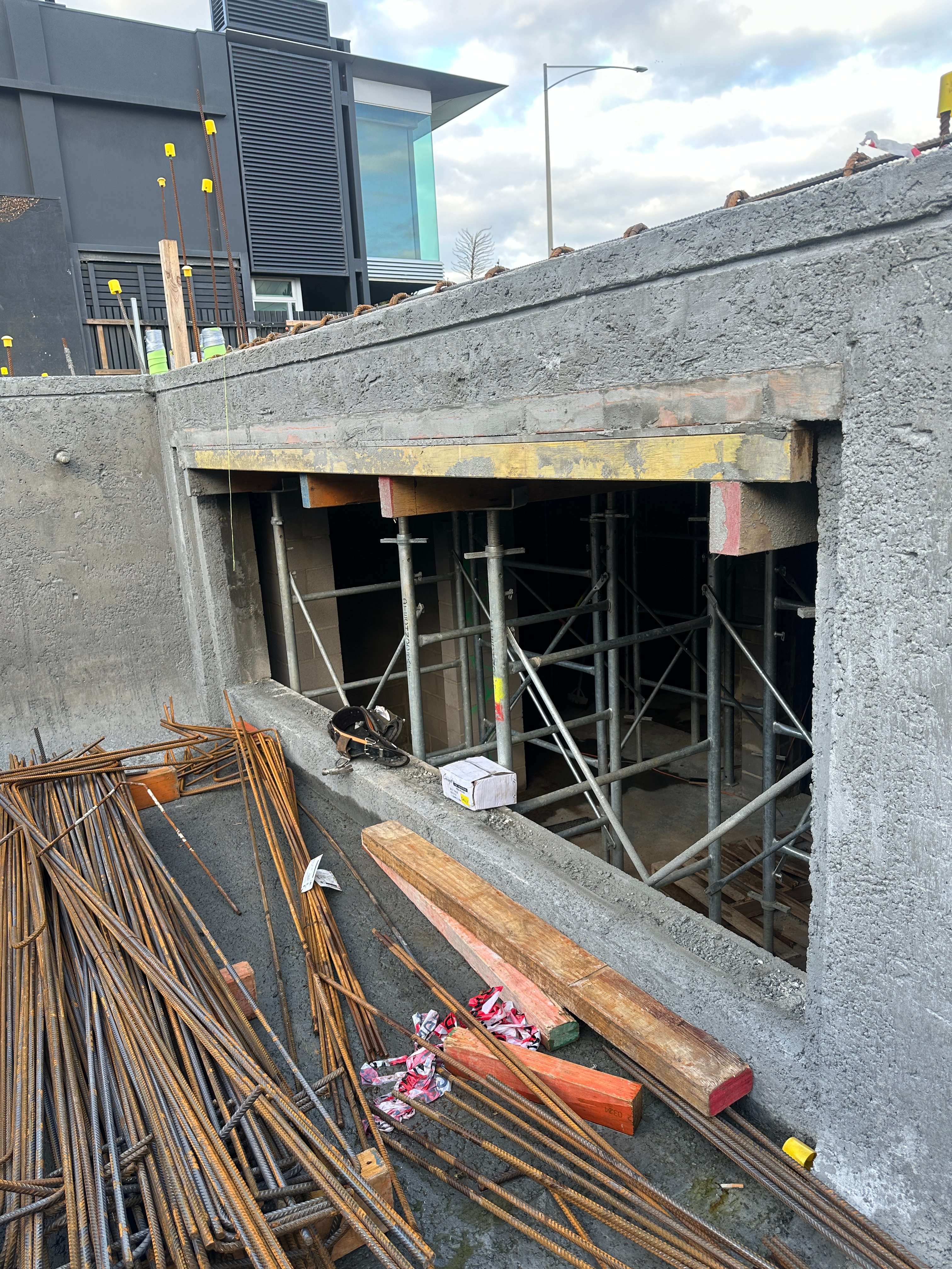 Pool wall construction showing rebar bundles and scaffolding structure